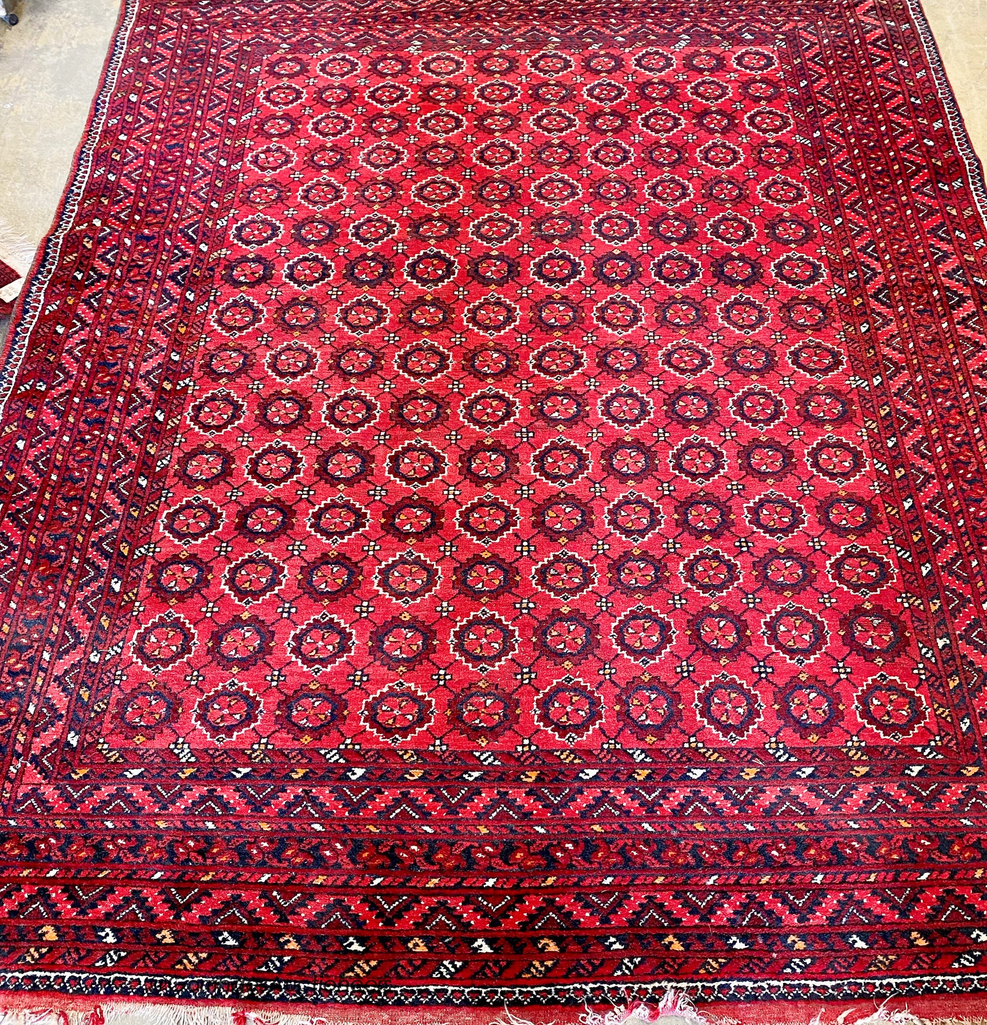 A Turkish red ground carpet. 296x240cm.